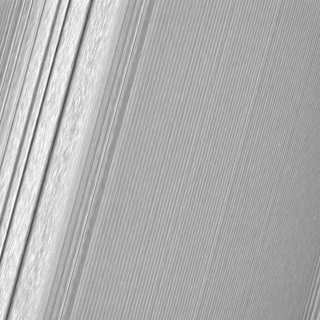 Cassini close-up of Saturn’s A ring, showing a density wave beside closely spaced diagonal moon wakes.